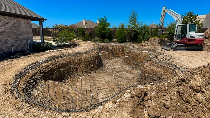 Inground pool construction site with rebar and excavation in Houston