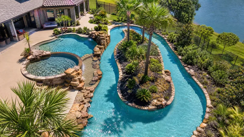 Backyard lazy river pool with waterfall built in the Houston area